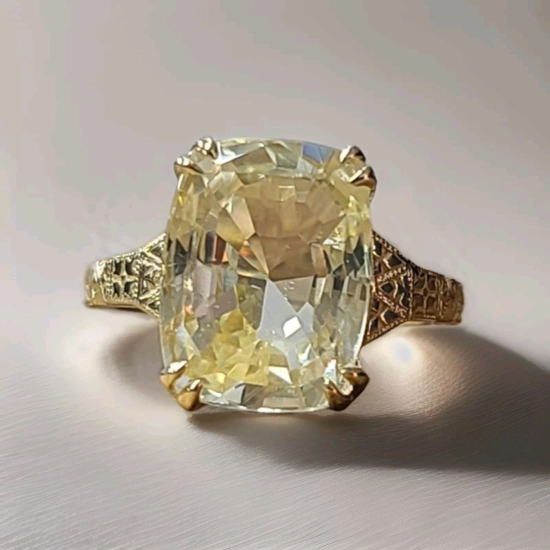 Vintage 14k Yellow Gold Engagement Ring 9.88ct Natural Yellow Sapphire Cushion: This vintage 14k yellow gold engagement ring is a stunning piece of fine jewelry. The ring features a 9.88ct natural yellow sapphire with a cushion shape and a prong setting. The sapphire is clean and