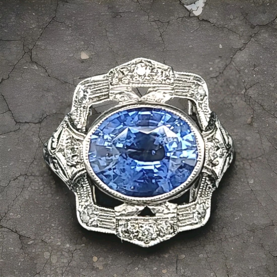 Vintage 18K White Gold Engagement Ring 4.27CT. Natural Blue Sapphire Oval: VINTAGE 18K WHITE GOLD ENGAGEMENT RING 4.27CT. NATURAL BLUE SAPPHIRE OVAL This stunning vintage engagement ring boasts a beautiful oval-shaped natural blue sapphire as its main stone, which has a tota