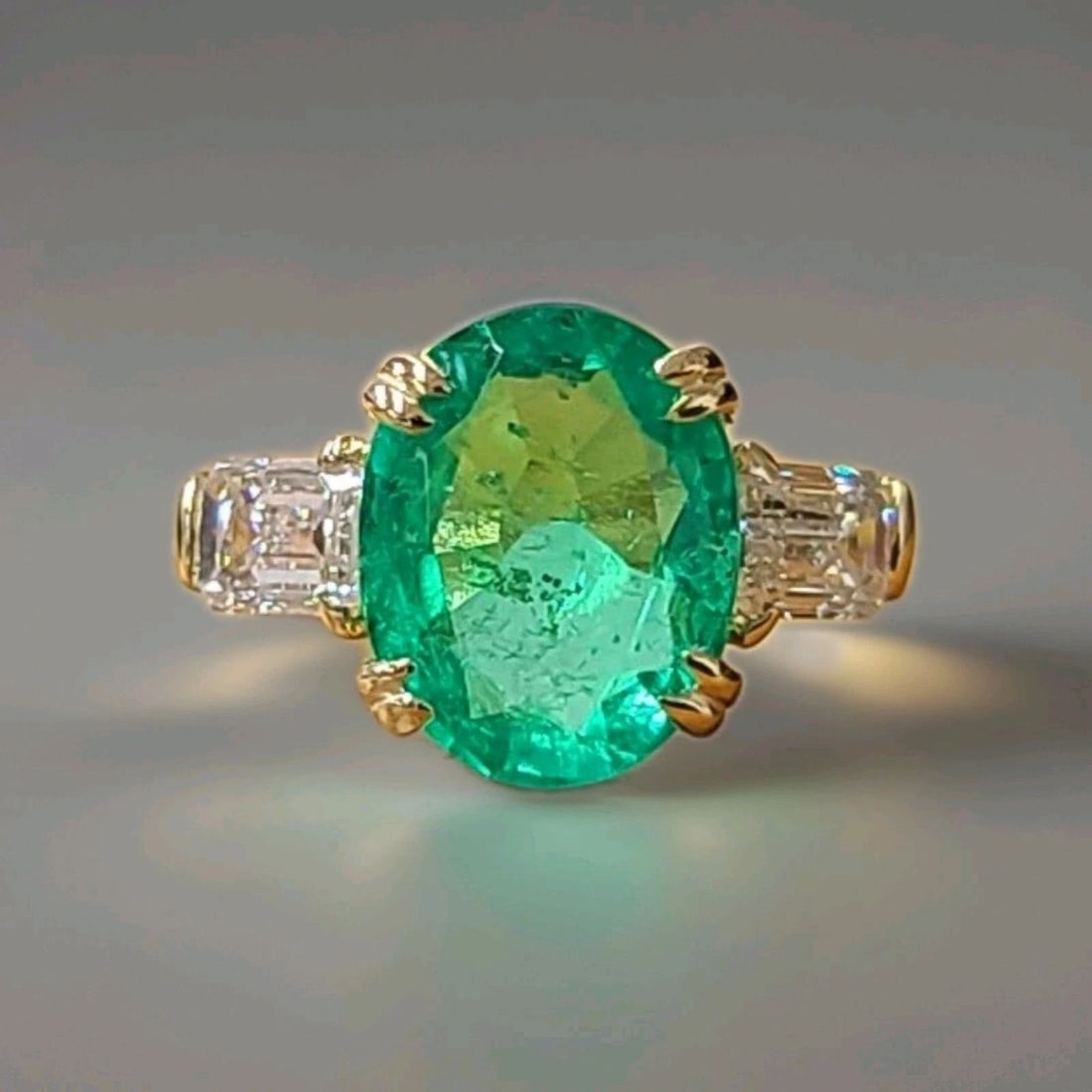 14k Yellow Gold Engagement Ring 5.10ct.Natural Colombian Emerald Oval GIA Cert: 14K YELLOW GOLD ENGAGEMENT RING 5.10CT.NATURAL COLOMBIAN EMERALD OVAL GIA CERT This 14k Yellow Gold Engagement Ring features a stunning 5.10ct Natural Colombian Emerald in an oval shape, accompanied b