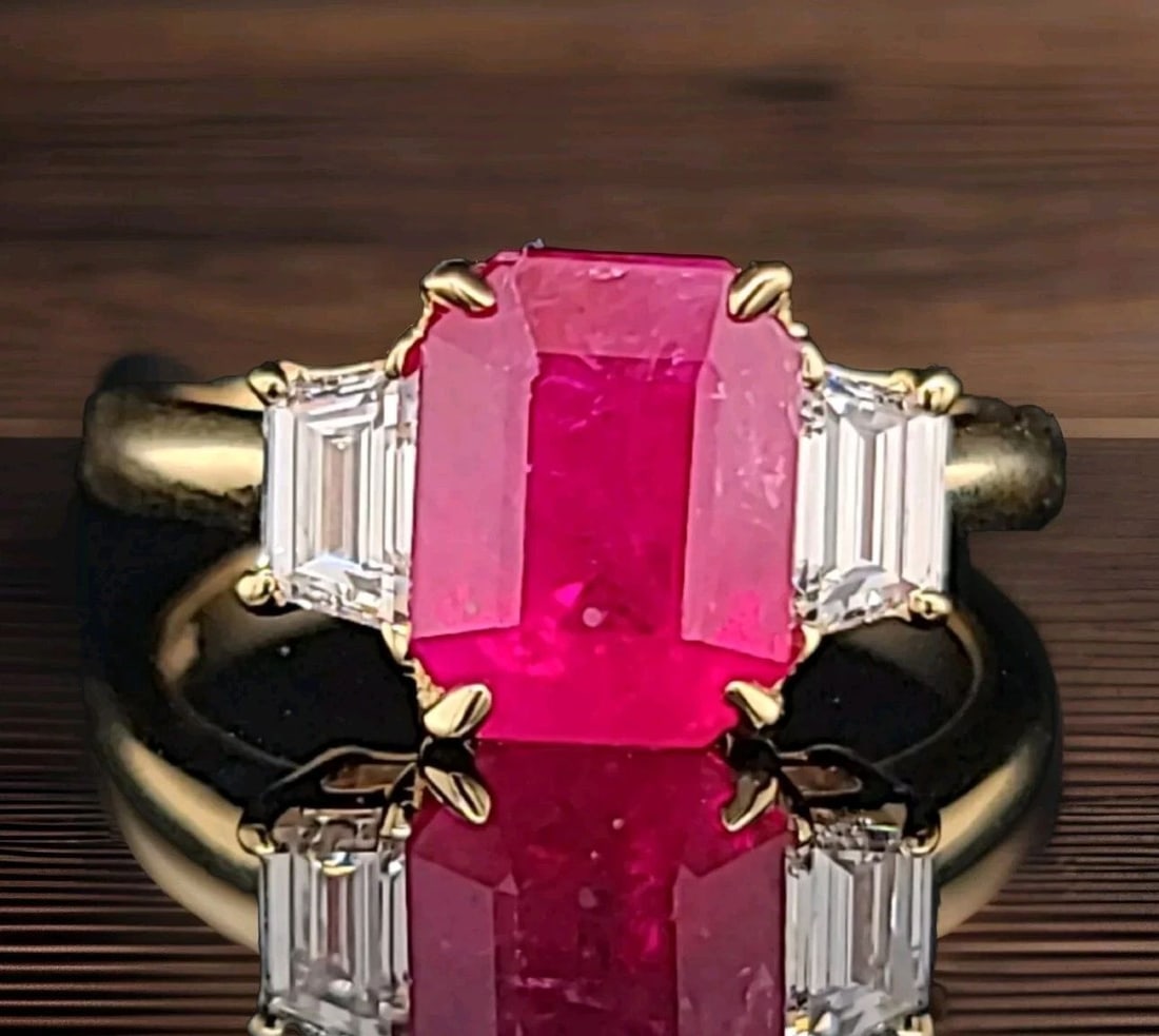 14k yellow gold Three-stone Engagement Ring 3.28ct.Natural Ruby Emerald Shape: 14K YELLOW GOLD THREE-STONE ENGAGEMENT RING 3.28CT.NATURAL RUBY EMERALD SHAPE This stunning three-stone engagement ring is crafted from 14k yellow gold and features a natural ruby stone in emerald sha
