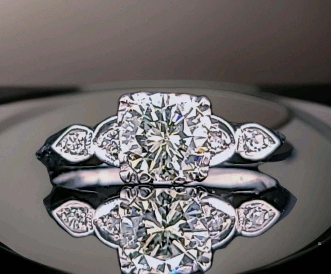 Vintage Platinum Engagement Ring 1.02CT.Natural Round Cut Diamond Circ 1930's: VINTAGE PLATINUM ENGAGEMENT RING 1.02CT.NATURAL ROUND CUT DIAMOND CIRC 1930'S This vintage platinum engagement ring from the 1930s features a 1.02CT natural round cut diamond as the main stone. The el