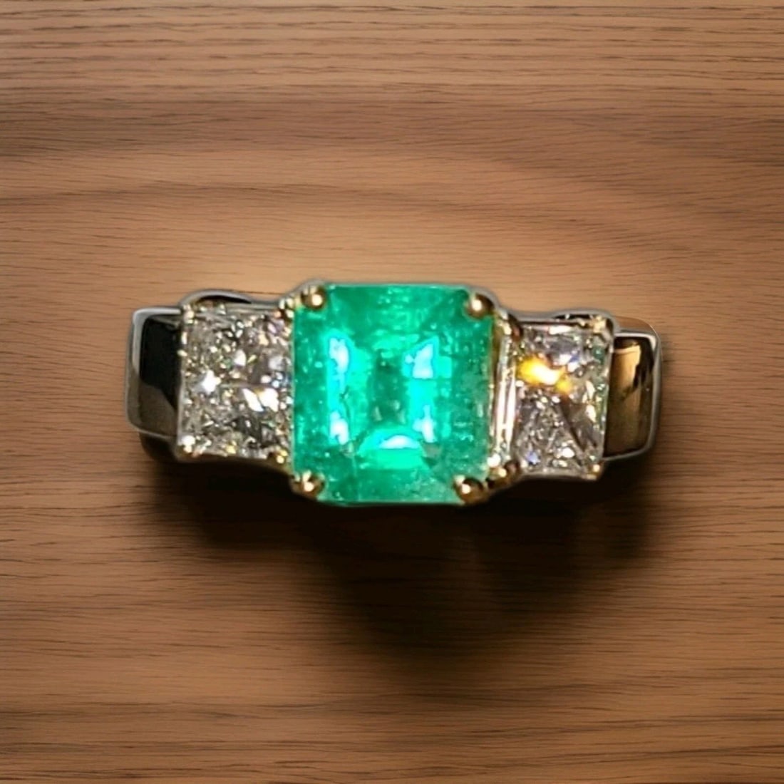 18K Yellow Gold Engagement Three-stone Ring 1.56CT. Natural Colombian Emerald: 18K YELLOW GOLD ENGAGEMENT RING 1.56CT. NATURAL GREEN COLOMBIA EMERALD DIAMOND This 18K Yellow Gold Engagement Ring features a stunning 1.56CT natural green Colombia Emerald as the main stone, with tw