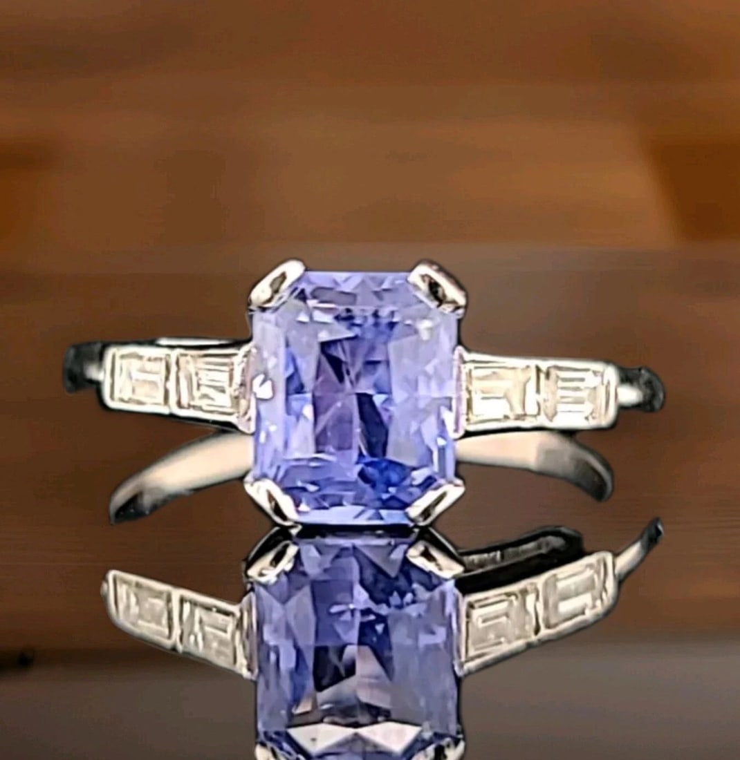Vintage 14k White Gold Engagement Ring 2.20ct. Natural Blue Sapphire Radiant Cut: VINTAGE 14K WHITE GOLD ENGAGEMENT RING 2.20CT. NATURAL BLUE SAPPHIRE RADIANT CUT This stunning 14k white gold ring features a magnificent 2.20ct natural blue sapphire in a radiant cut, accented by spa