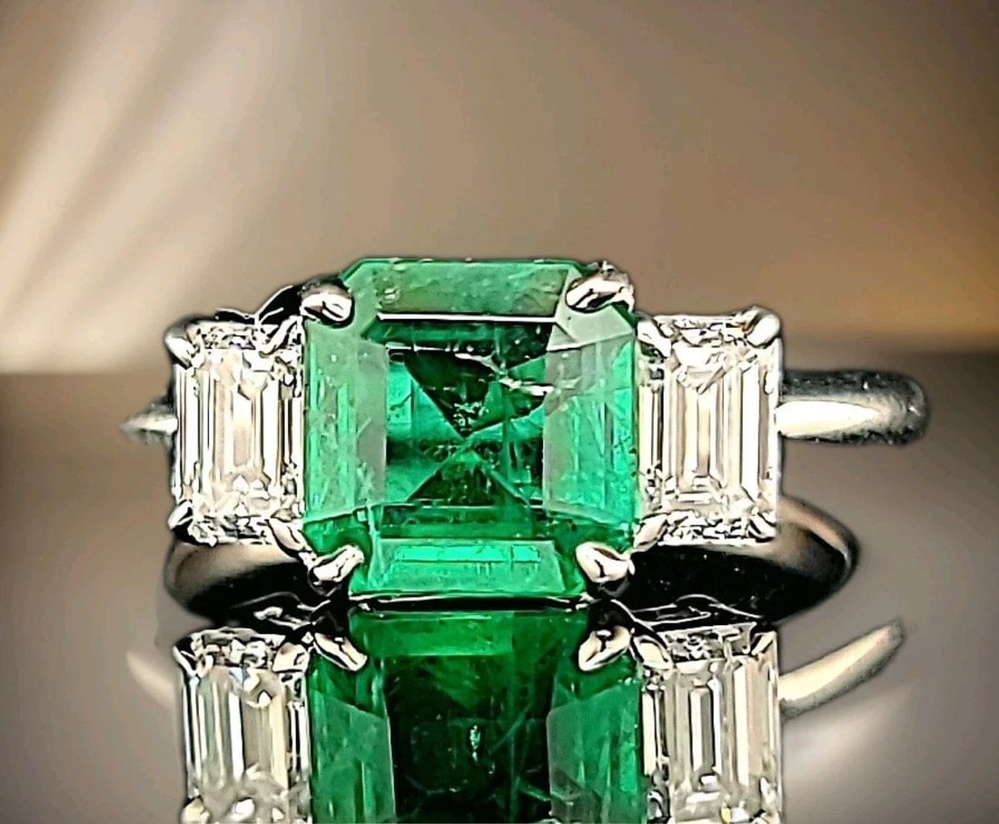 14K White Gold Natural Emerald Ring 1.73ct Radiant Cut w/ 0.80ct Diamond Accents: 14K WHITE GOLD ENGAGEMENT RING 1.73CT. NATURAL GREEN EMERALD RADIANT SHAPE GORGEOUS 14K WHITE GOLD gem natural emerald in radiant shape. center natural emerald weight 1.73ct. size 7.5x7.4mm very nice 