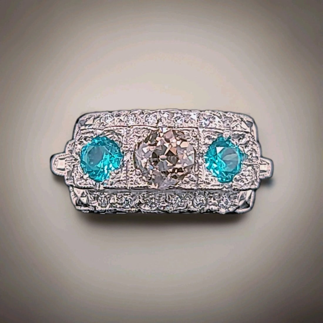 Vintage Platinum Ring 1.48ct.Natural Old Cut Champagne Diamond Blue Tourmaline: VINTAGE PLATINUM RING 1.48CT.NATURAL OLD CUT CHAMPAGNE DIAMOND BLUE TOURMALINE This vintage platinum ring features natural old cut champagne diamond with side blue tourmaline gemstone. The three-stone