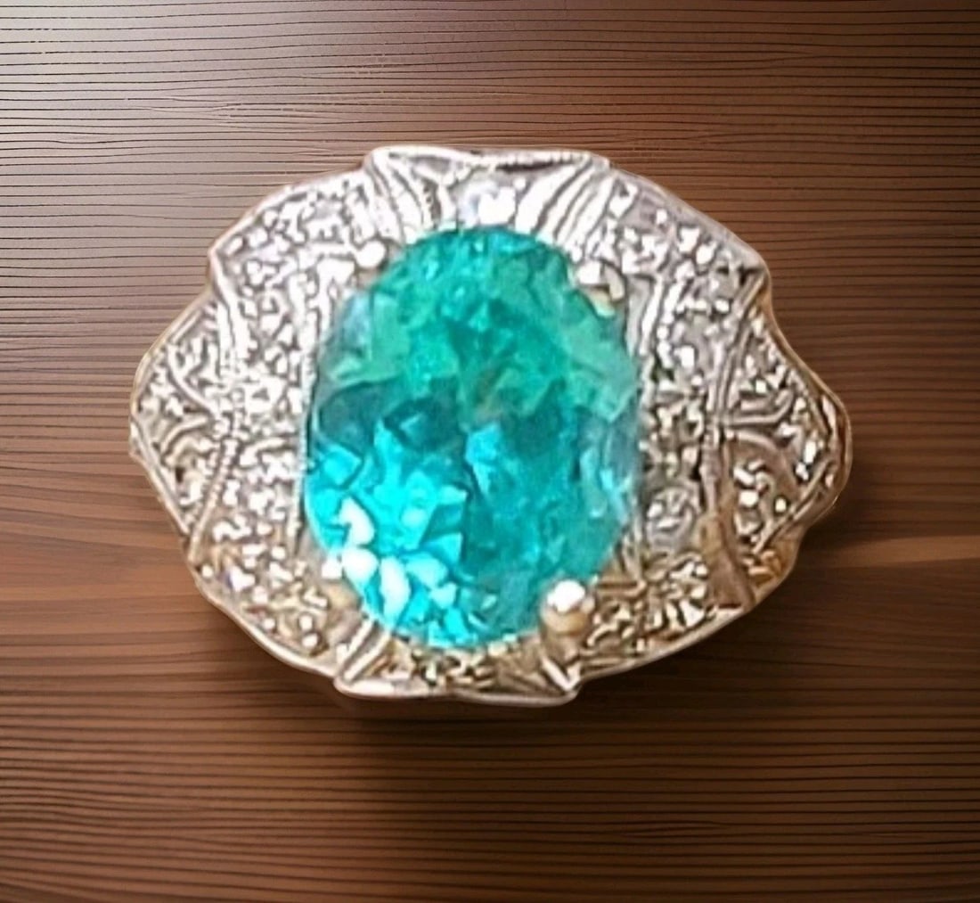 Vintage Filigree Platinum Engagement Ring 4.10ct. Blue Neon Tourmaline Oval Cut: Vintage Filigree Platinum Engagement Ring 4.10ct. Blue Neon Tourmaline Oval Cut This exquisite vintage filigree ring showcases a 4.10-carat oval-cut lab-grown blue tourmaline (8x 10 mm) with a vibrant