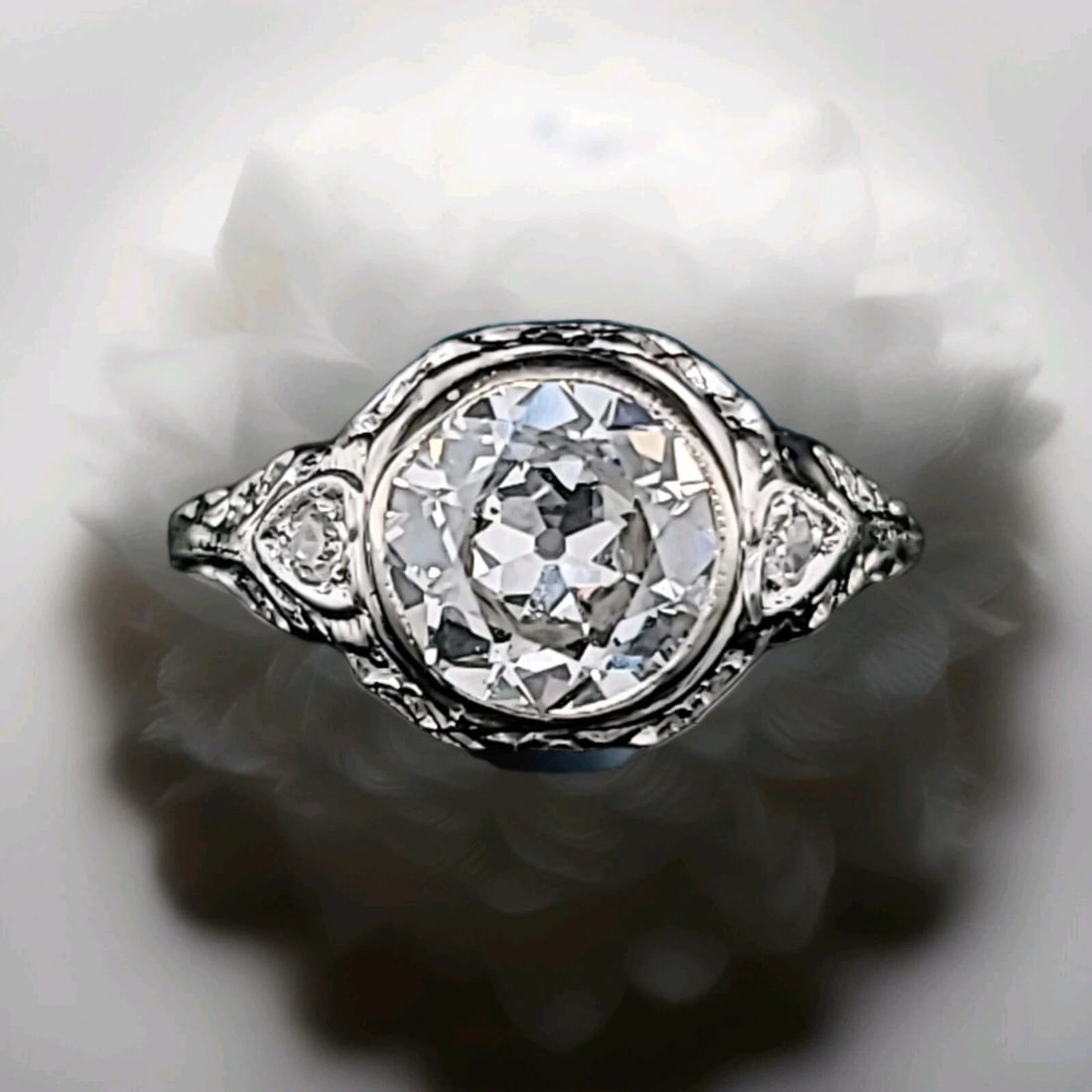 14k white gold Filigree Engagement Ring 1.65ct. Lab Grown Old Euro Cut Diamond: 14K WHITE GOLD FILIGREE ENGAGEMENT RING 1.65CT. LAB GROWN OLD EURO CUT DIAMOND This 14k white gold Filigree Engagement Ring features a 1.65ct lab grown Old Euro Cut Diamond as the main stone. The vint