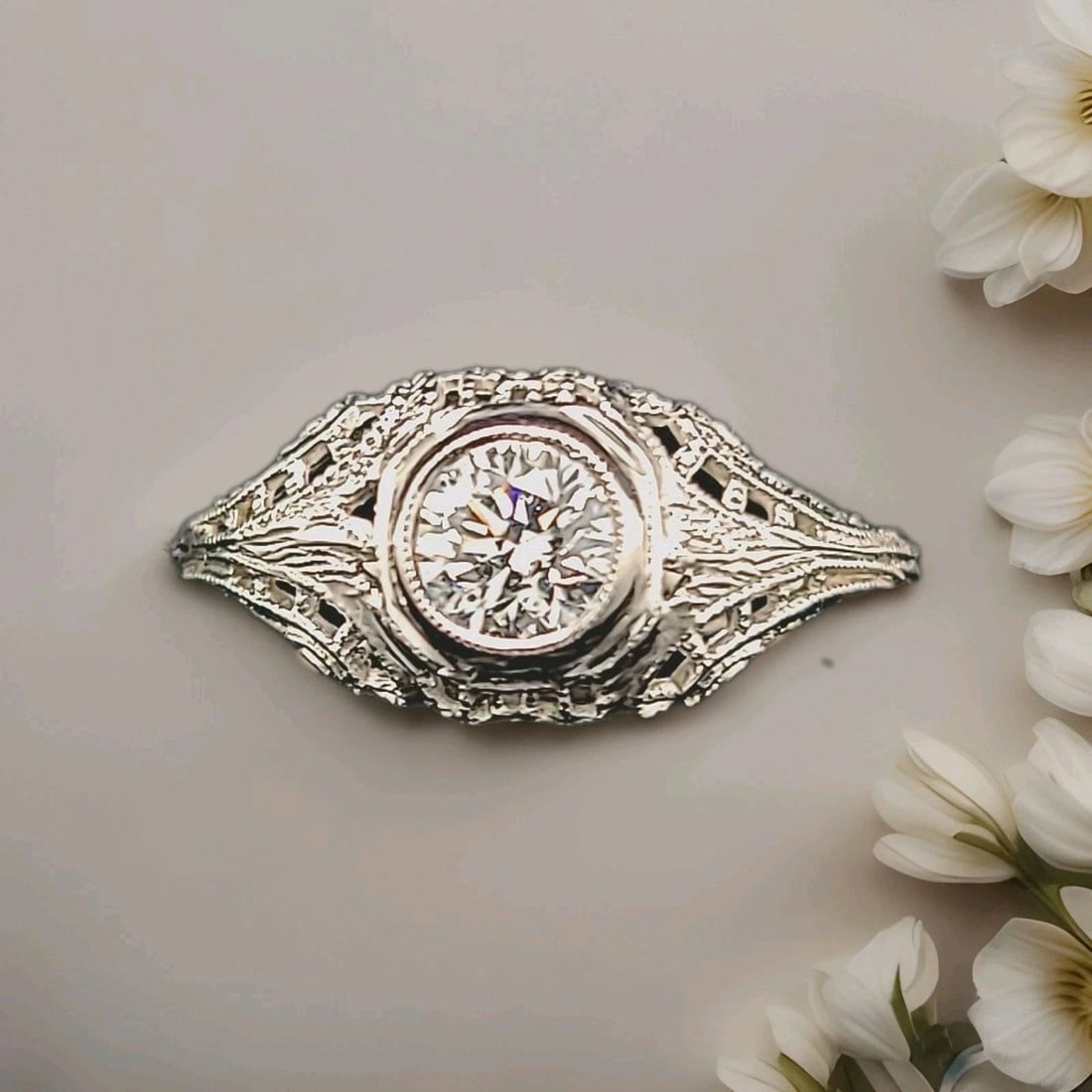 18k white gold vintage filigree engagement ring 0.52ct. natural round Diamond: 18K WHITE GOLD VINTAGE FILIGREE ENGAGEMENT RING 0.52CT. NATURAL ROUND DIAMOND This is a vintage 18k white gold engagement ring with a filigree design. The ring features a 0.52ct natural round diamond 