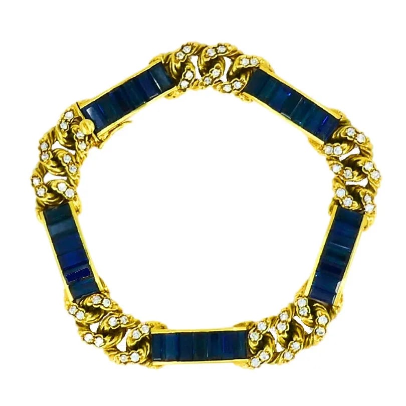 VINTAGE FRED PARIS BRACELET SAPPHIRE DIAMOND 18K GOLD ESTATE JEWELRY: HEMMERLE 18 karat Yellow Gold Sapphire Leather Spiral Bracelet A vintage Fred Paris bracelet with sapphires and diamonds, crafted in 18k gold. The bracelet features sleek baguette cut blue sapphires, 