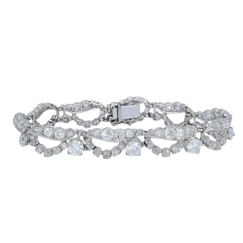 FRENCH PLATINUM DIAMOND OPENWORK DIAMOND BRACELET, 1960S: FRENCH PLATINUM DIAMOND OPENWORK DIAMOND BRACELET, 1960S MATERIALS Platinum GEMSTONE Diamond WEIGHT 25.7 Grams MEASUREMENTS 6 1/2" x 3/8" HALLMARKS Maker's Mark ITEM DETAILS Art Deco Platinum Diamond 