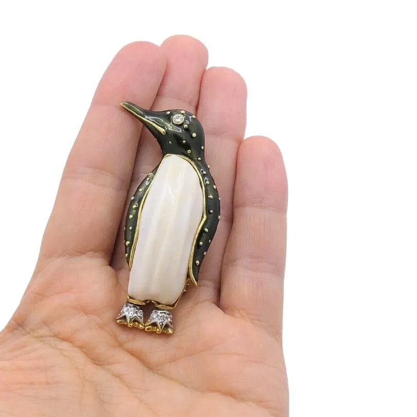 ALDO CIPULLO FOR CARTIER BROOCH PENGUIN ENAMEL DIAMOND 18K GOLD: DESIGNER: Aldo Cipullo for Cartier CIRCA: 1970’s MATERIALS: 18 karat Yellow Gold, Enamel GEMSTONE: Diamond WEIGHT: 34 grams MEASUREMENTS: 2 3/8" x 7/8" HALLMARKS: Cartier, A. Cipullo ITEM DETAILS: A