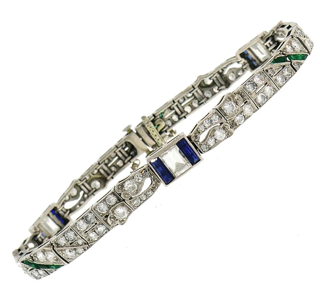 ART DECO PLATINUM BRACELET DIAMOND SAPPHIRE EMERALD: ART DECO PLATINUM BRACELET DIAMOND SAPPHIRE EMERALD Art Deco Diamond Sapphire Emerald Bracelet A delicate Art Deco bracelet created in the 1930s.The bracelet is made of platinum, step cut (1.50 carats
