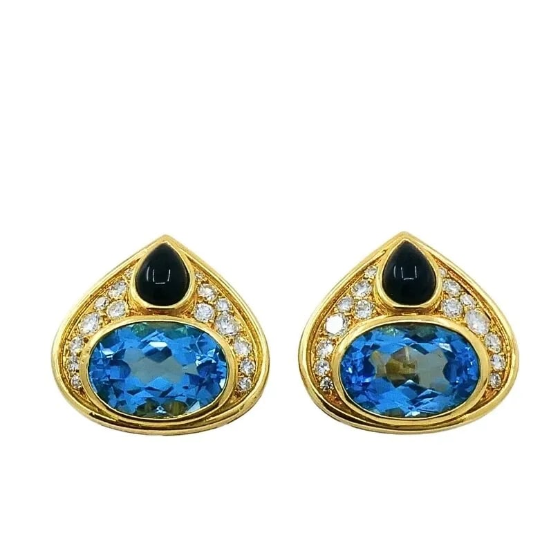 MARINA B 18K GOLD TOPAZ ONYX & DIAMOND CLIP-ON EARRINGS: MARINA B 18K GOLD TOPAZ ONYX & DIAMOND CLIP-ON EARRINGS DESIGNER: Marina B CIRCA: 1980’s MATERIALS: 18k Gold GEMSTONE: Topaz, Onyx & Diamond WEIGHT: 18.3 Grams MEASUREMENTS: 3/4" x 3/4" HALLMARKS: M
