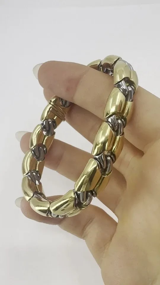 VINTAGE BVLGARI 18K GOLD STEEL LINK BRACELET: Vintage Bvlgari 18k Gold Steel Link Bracelet KL EETO This Bulgari Oro Acciaio bracelet is crafted in 18k yellow gold and steel, reflecting the bold, industrial design language associated with the hous