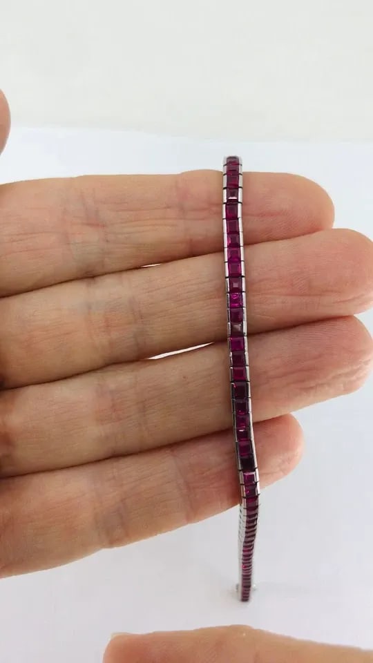 ART DECO RUBY TENNIS BRACELET PLATINUM: ART DECO RUBY TENNIS BRACELET PLATINUM Art Deco Ruby Tennis Bracelet Platinum (tested) The bracelet features a continuous line of square-cut rubies, each set in an individual box-style link. This plat