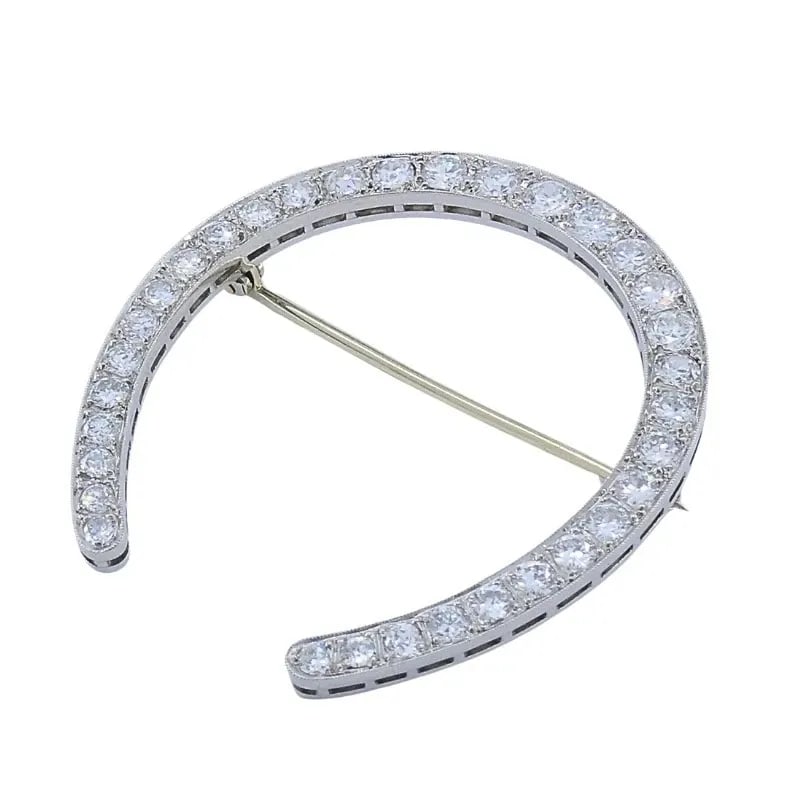 EDWARDIAN PLATINUM DIAMOND HORSESHOE BROOCH: EDWARDIAN PLATINUM DIAMOND HORSESHOE BROOCH MATERIALS Platinum GEMSTONE Diamonds WEIGHT 10.7 Grams MEASUREMENTS 3/16” x 1 5/8” ITEM DETAILS Edwardian Platinum Diamond Horseshoe Brooch This