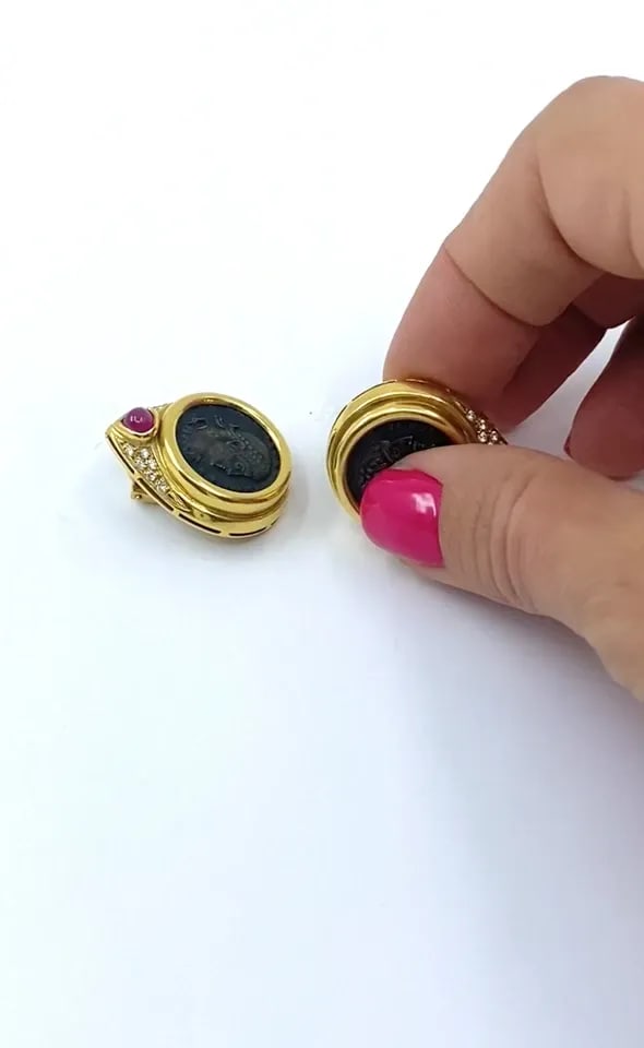 ANCIENT COIN 18K GOLD EARRINGS RUBY: ANCIENT COIN 18K GOLD EARRINGS RUBY Product details: DESIGNER: Unknown CIRCA: 1980’s MATERIALS: 18k Yellow Gold, Silver GEMSTONE: Ruby & Diamond WEIGHT: 33.4 Grams MEASUREMENTS: Diameter - 7/8 " Len