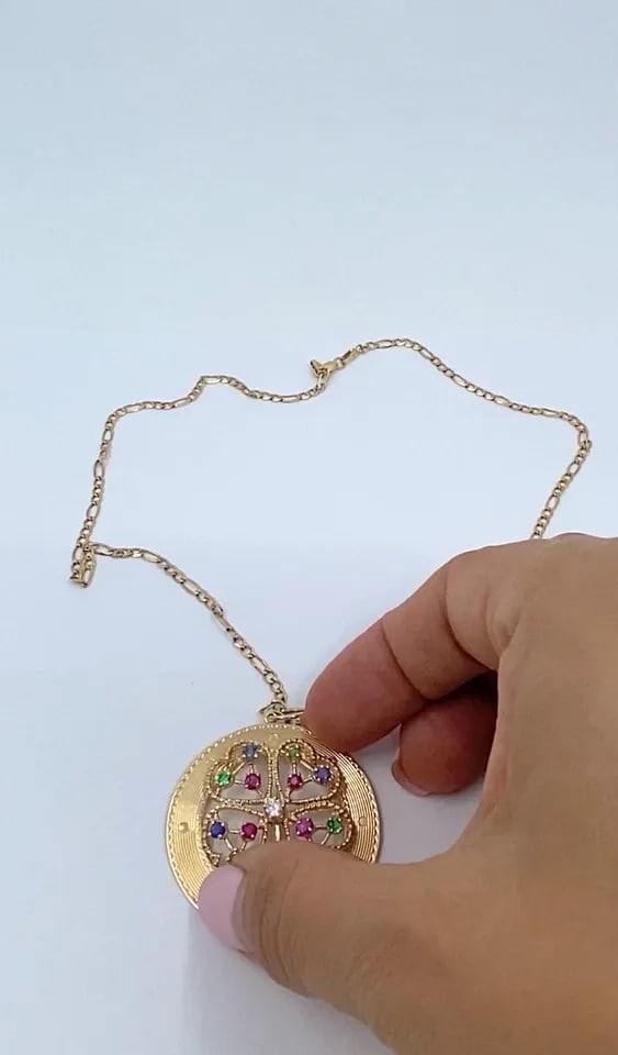 14K GOLD GEMSTONES CLOVER PENDANT NECKLACE: 14K GOLD GEMSTONES CLOVER PENDANT NECKLACE DESIGNER: Unknown CIRCA: Late 20th Century MATERIALS: 14k Gold GEMSTONE: Ruby, Sapphire, Emerald, Diamond WEIGHT: 12.8 Grams MEASUREMENTS: Pendant Diameter -