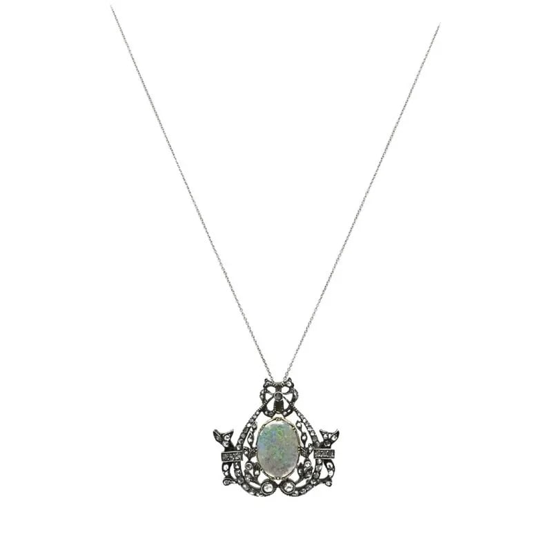 VINTAGE OPAL DIAMOND PENDANT 10K GOLD SILVER AND 18K GOLD CHAIN: VINTAGE OPAL DIAMOND PENDANT 10K GOLD SILVER AND 18K GOLD CHAIN Product details: DESIGNER: Unknown CIRCA: Early 20th Century MATERIALS: 18k Gold Chain, 10k Gold Silver Pendant GEMSTONE: Opal, Diamond 