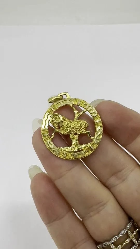 VINTAGE 18K GOLD ARIES ASTROLOGICAL ZODIAC PENDANT: VINTAGE 18K GOLD ARIES ASTROLOGICAL ZODIAC PENDANT An Aries pendant, crafted in 18K yellow gold. The pendant is open-work and features a finely detailed ram, the traditional symbol of Aries, framed wi