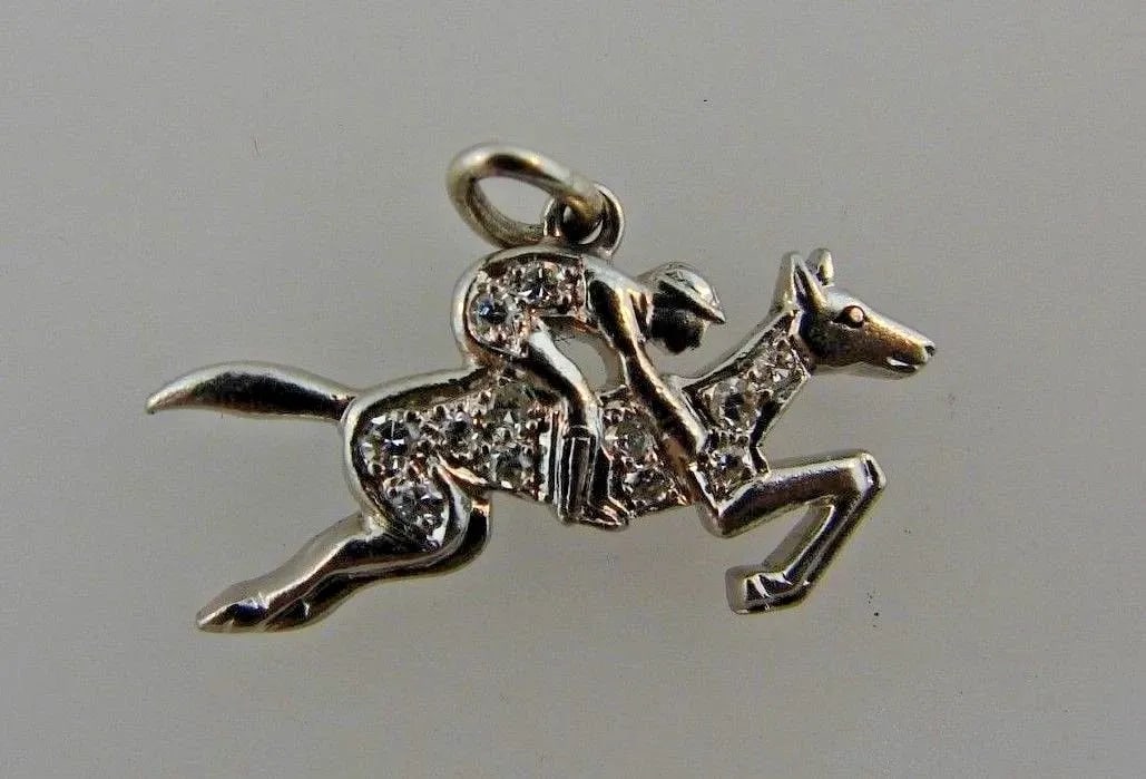 ART DECO PLATINUM & DIAMOND EQUESTRIAN CHARM CIRCA 1920S: ART DECO PLATINUM & DIAMOND EQUESTRIAN CHARM CIRCA 1920S Platinum & Diamond Equestrian Charm Art Deco This is a must for a collector. The weight is 2 grams. The height with bail is 5/8 of an inch. The