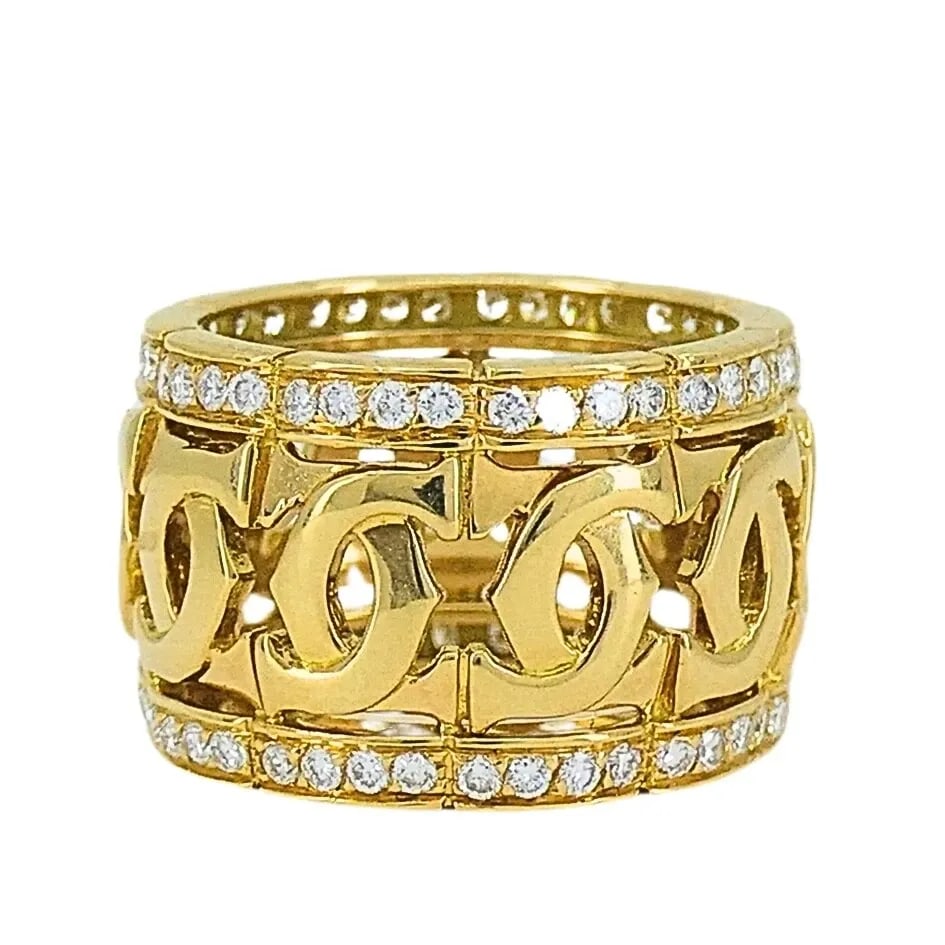 CARTIER ENTRELACES C DE CARTIER DIAMOND RING WIDE BAND: CARTIER ENTRELACES C DE CARTIER DIAMOND RING WIDE BAND Product details: DESIGNER: Cartier CIRCA: 1990’s MATERIALS: 18k Yellow Gold GEMSTONE: 0.65 cts Round Brilliant Cut Diamond WEIGHT: 12.6 Grams M