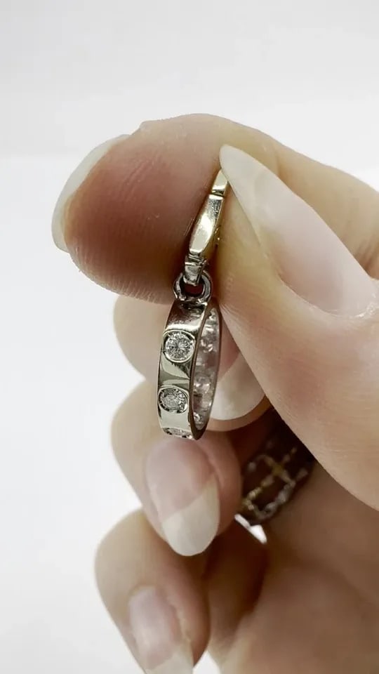 CARTIER DIAMOND LOVE PENDANT CHARM IN 18K WHITE GOLD: CARTIER DIAMOND LOVE PENDANT CHARM IN 18K WHITE GOLD KL JTOO This Cartier diamond Double C logo charm pendant is crafted in 18k white gold and features the Maison’s iconic interlocking Cartier “C&