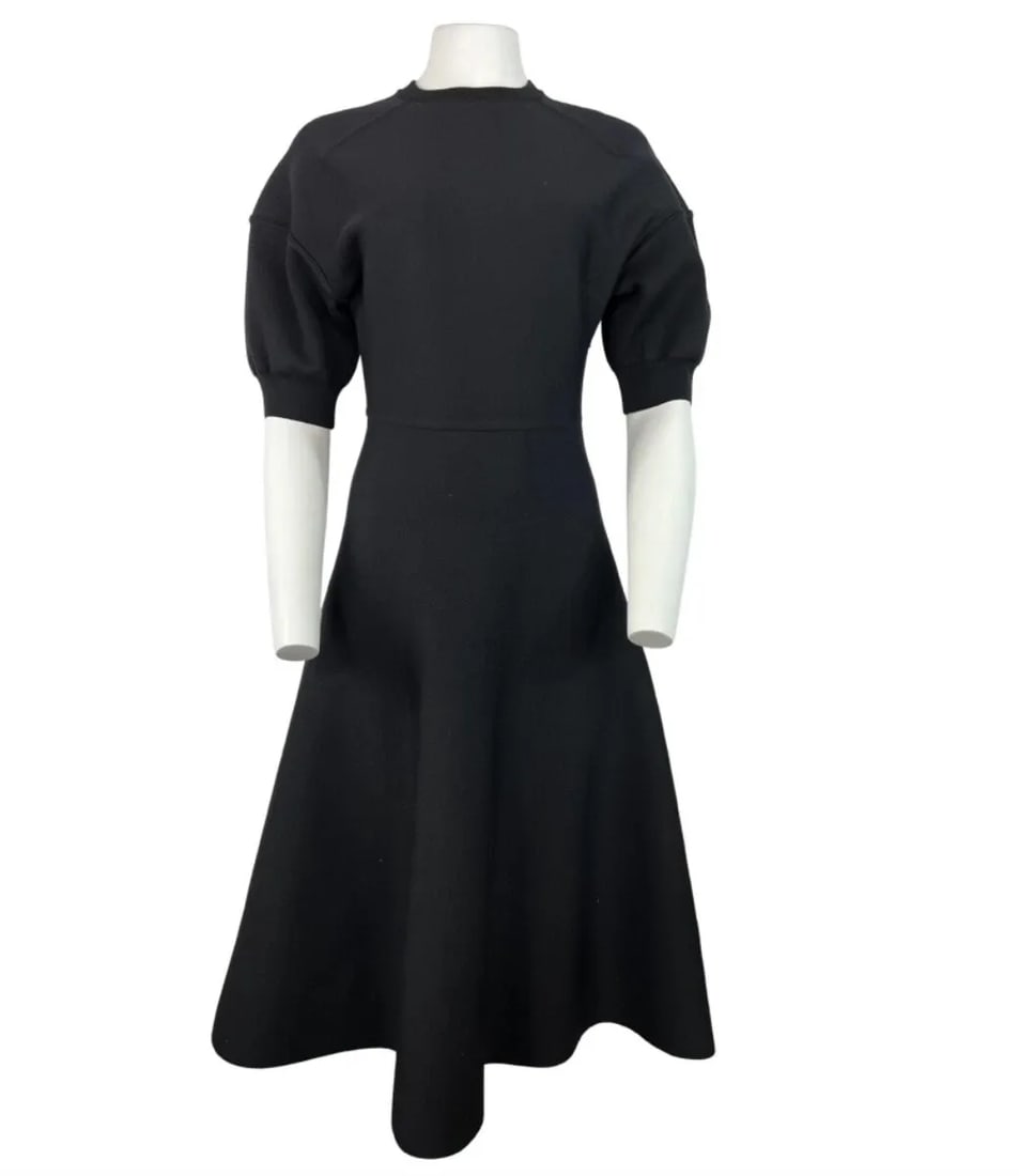 CHRISTIAN DIOR BLACK WOOL MIDI DRESS, SIZE 6: CHRISTIAN DIOR BLACK WOOL MIDI DRESS, SIZE 6 CHRISTIAN DIOR BLACK WOOL MIDI DRESS, SIZE 6 The dress features crew neck line, short balloon sleeves, midi length flare skirt, rear zip closure and knit f