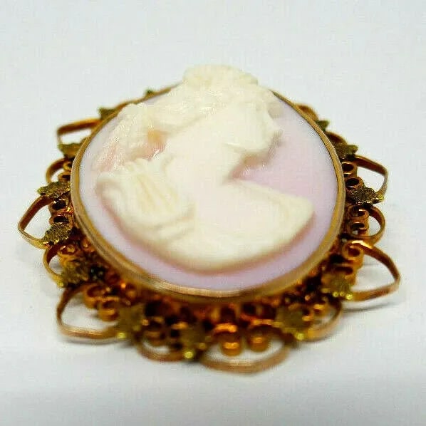 ANTIQUE CARVED ANGEL SKIN CORAL CAMEO 10K YELLOW GOLD PIN PENDANT: ANTIQUE CARVED ANGEL SKIN CORAL CAMEO 10K YELLOW GOLD PIN PENDANT Beautiful Antique carved angel skin coral cameo 10k yellow gold pin pendant Has a loop on top to be worn as a pendant Measurements: 1 