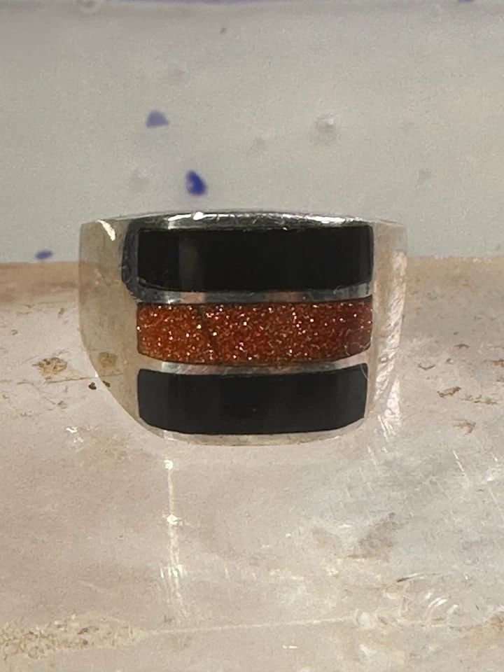 ONYX RING GOLDSTONE BAND SIZE 12 MEXICO BAND STERLING SILVER WOMEN MEN: ONYX RING GOLDSTONE BAND SIZE 12 MEXICO BAND STERLING SILVER WOMEN MEN Onyx ring goldstone band size 12 Mexico band sterling silver women men Size 12 Weight 16g Length. 1/2" Width 1/2" Thinnest part 3