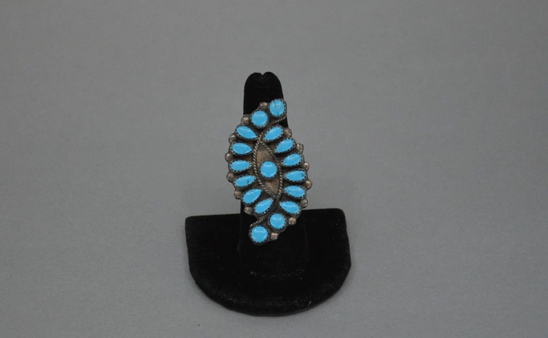 LARGE VINTAGE NAVAJO RING - 17 TURQUOISE STONES - SZ 7.5 - 2" TALL: LARGE VINTAGE NAVAJO RING - 17 TURQUOISE STONES - SZ 7.5 - 2" TALL This large old pawn Navajo ring has 17 vibrant blue turquoise stones set into serrated bezel. The silver is nickel silver. not sterli