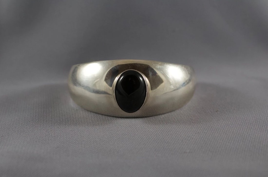 NAVAJO STERLING AND ONYX BRACELET: NAVAJO STERLING AND ONYX BRACELET Item Description: 1" Wide 5 3/8 " Inside with a 1 1/4 " Opening P