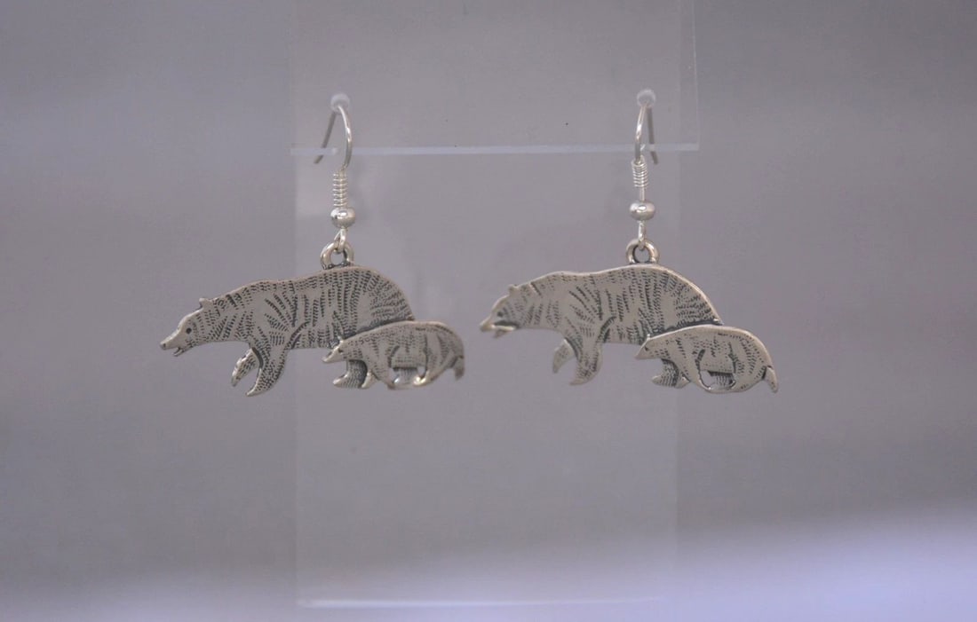 NAVAJO STERLING SILVER DANGLE EARRINGS - MOTHER BEAR AND CUB - 1.5" DROP: NAVAJO STERLING SILVER DANGLE EARRINGS - MOTHER BEAR AND CUB - 1.5" DROP This lovely pair of Navajo handcrafted dangle earrings show a mother bear walking with her cub. They have a 1.5" drop and measu
