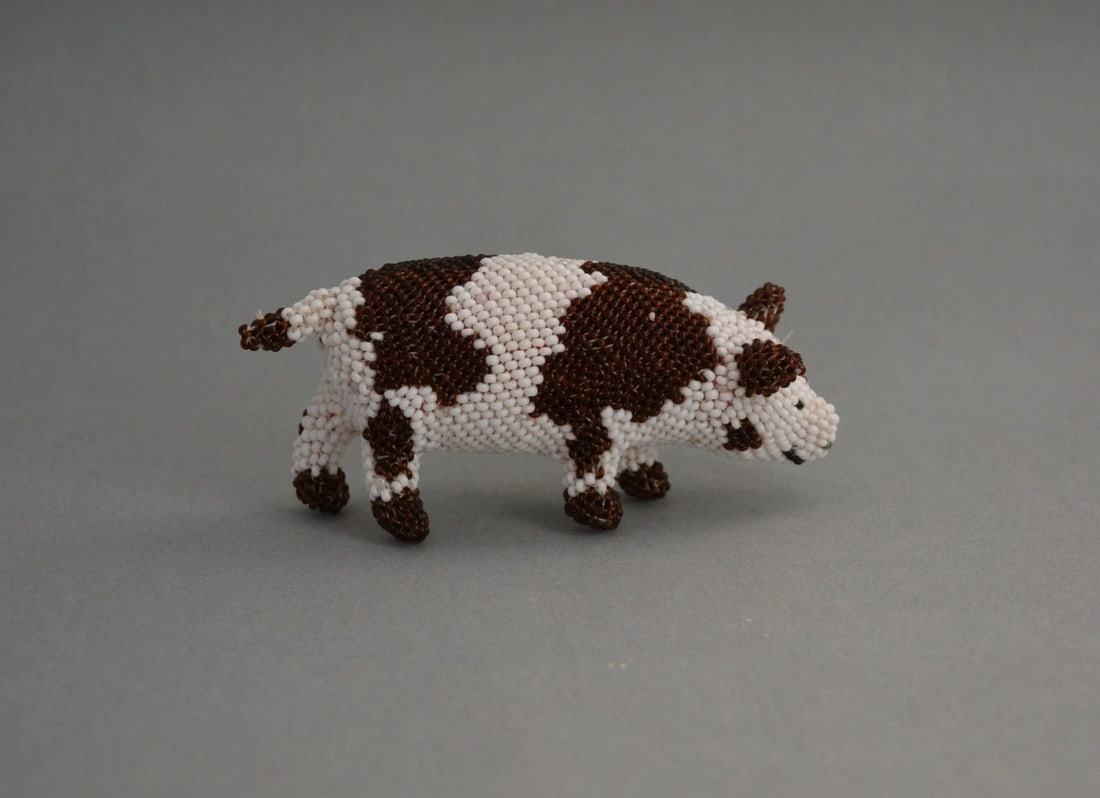 ZUNI HAND BEADED SPOTTED PIG FIGURINE - TILDON MARTZA - 4" LONG X 1 3/4": ZUNI HAND BEADED SPOTTED PIG FIGURINE - TILDON MARTZA - 4" LONG X 1 3/4" This wonderful spotted pig has been beautifully crafted by Zuni artist Tildon Martza. It measures 4" long by 1 3/4" high. This 