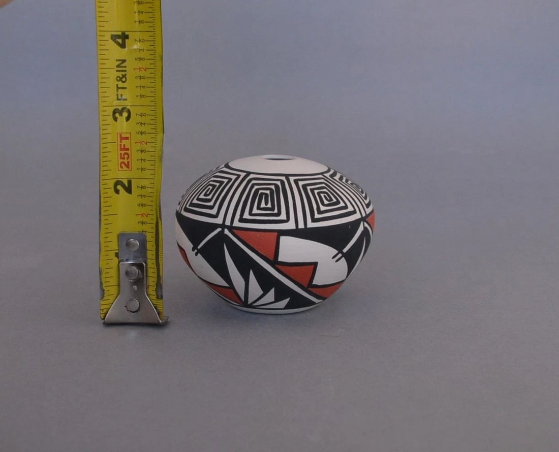 J. P. TORIVIO - SMALL SEED JAR POT - HANDPAINTED POLYCHROME DESIGNS - 2 1/8": J. P. TORIVIO - SMALL SEED JAR POT - HANDPAINTED POLYCHROME DESIGNS - 2 1/8" This small seed jar has been beautifully crafted by T. P. Torivio of the Acoma Pueblo. It is 2 1/8" tall and approximately 