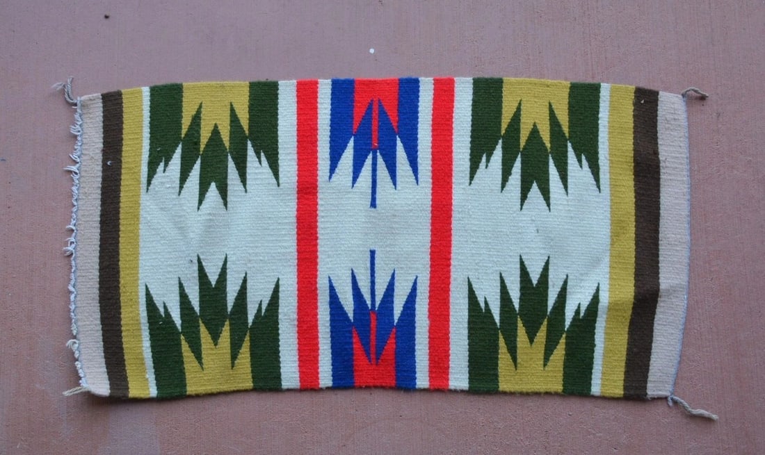 VINTAGE NAVAJO RUG - VIBRANT RED, BLUE, TAN, WHITE - 35.5" X 18": VINTAGE NAVAJO RUG - VIBRANT RED, BLUE, TAN, WHITE - 35.5" X 18" Measures 35.5" x 18". One vertical side is a little longer than the other. There are some small light dirt stains on one side. See phot