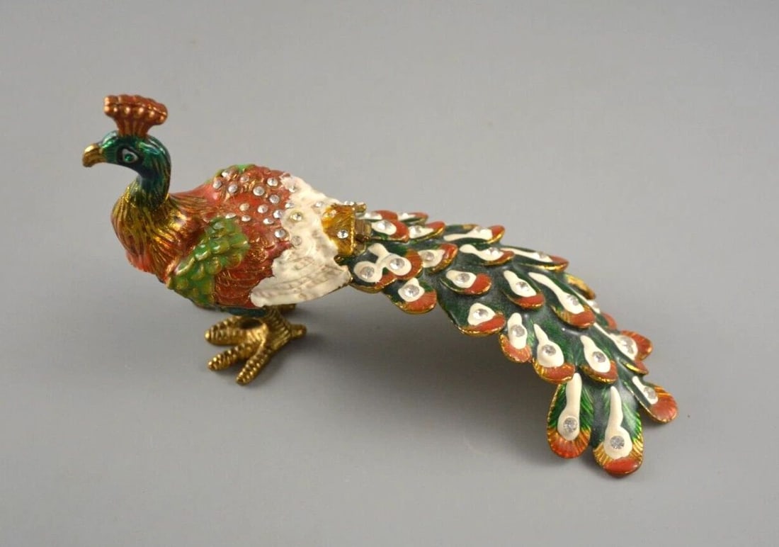 MINIATURE PEACOCK TRINKET BOX - HAND PAINTED ENAMEL - SWAROWSKI CRYSTALS - CIEL: MINIATURE PEACOCK TRINKET BOX - HAND PAINTED ENAMEL - SWAROWSKI CRYSTALS - CIEL Item Description: This colorful peacock trinket box sparkles with hand-set swarowski crystals. The body and inside of th