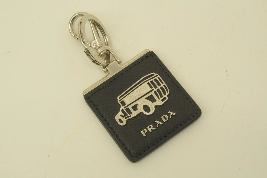AUTHENTIC PRADA LEATHER KEYCHAIN SP CAR LOGO SILVER DANGLE BAG ACCESSORY: AUTHENTIC PRADA LEATHER KEYCHAIN SP CAR LOGO SILVER DANGLE BAG ACCESSORY Authentic Prada Leather Keychain SP Car Logo Silver Dangle Bag Accessory Prada Bauli Valigeria Car, Vehicle Key Chain, Bag Char