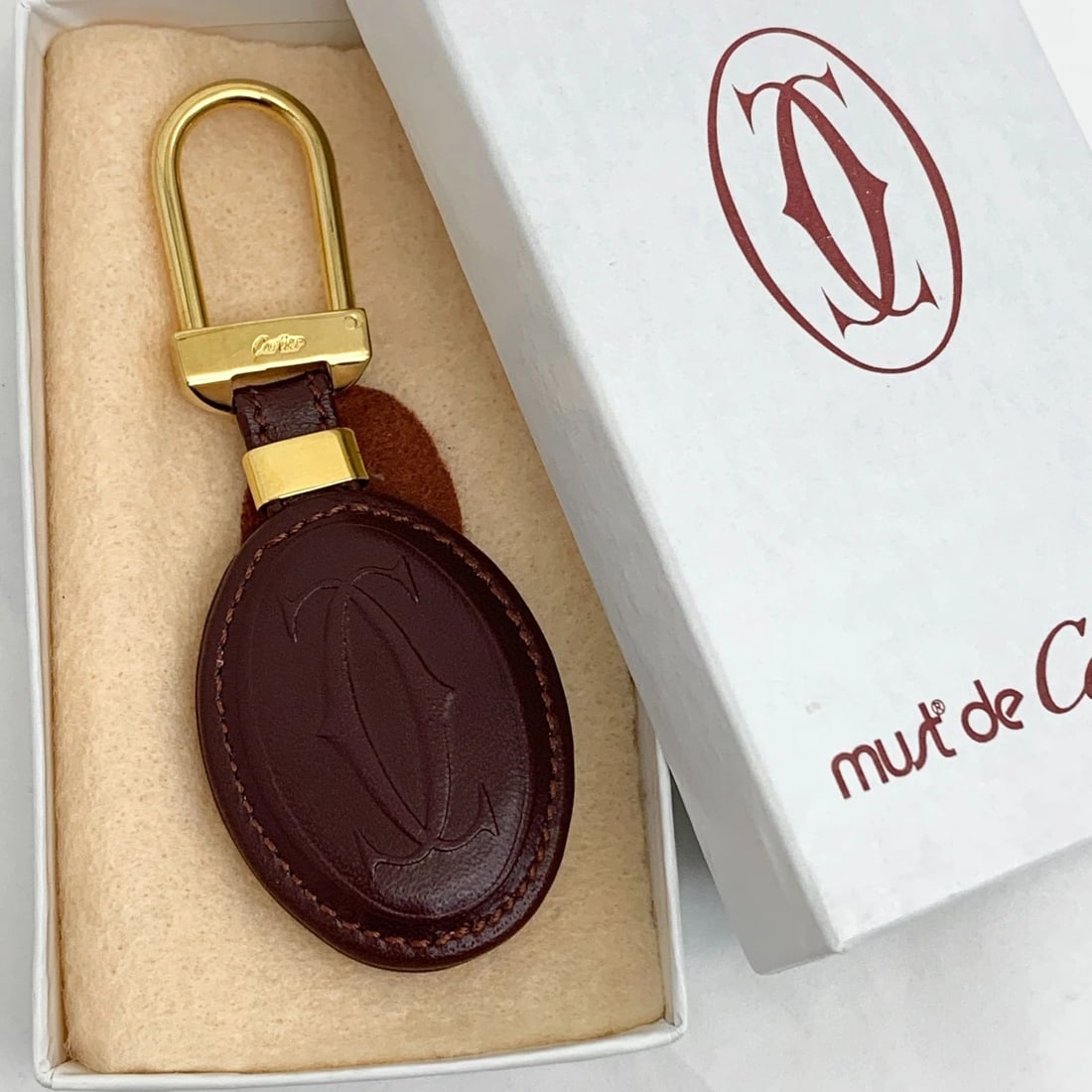 AUTHENTIC CARTIER DECOR LOGO LEATHER CLASSIC KEYCHAIN GOLD GP SIGNATURE CHARM: AUTHENTIC CARTIER DECOR LOGO LEATHER CLASSIC KEYCHAIN GOLD GP SIGNATURE CHARM AUTHENTIC CARTIER DECOR LOGO LEATHER CLASSIC KEYCHAIN GOLD GP SIGNATURE CHARM Cartier Signature, Classic, Logo Keychain Ch