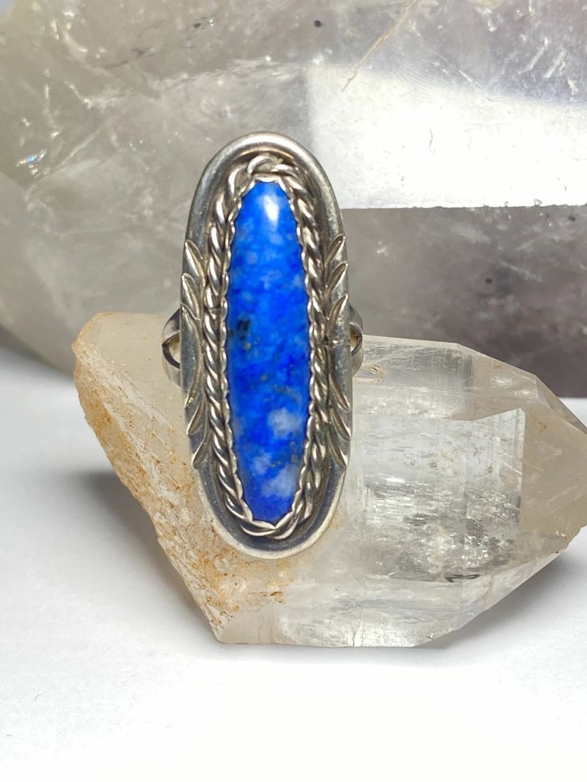 LONG BLUE LAPIS ? RING NAVAJO SOUTHWEST STERLING SILVER WOMEN: LONG BLUE LAPIS ? RING NAVAJO SOUTHWEST STERLING SILVER WOMEN Long blue lapis ? or sodalite Ring southwest sterling silver women Size 6.75 Weight 9 Length. 1 5/8" Width. 5/8" Thinnest part of band 1/8