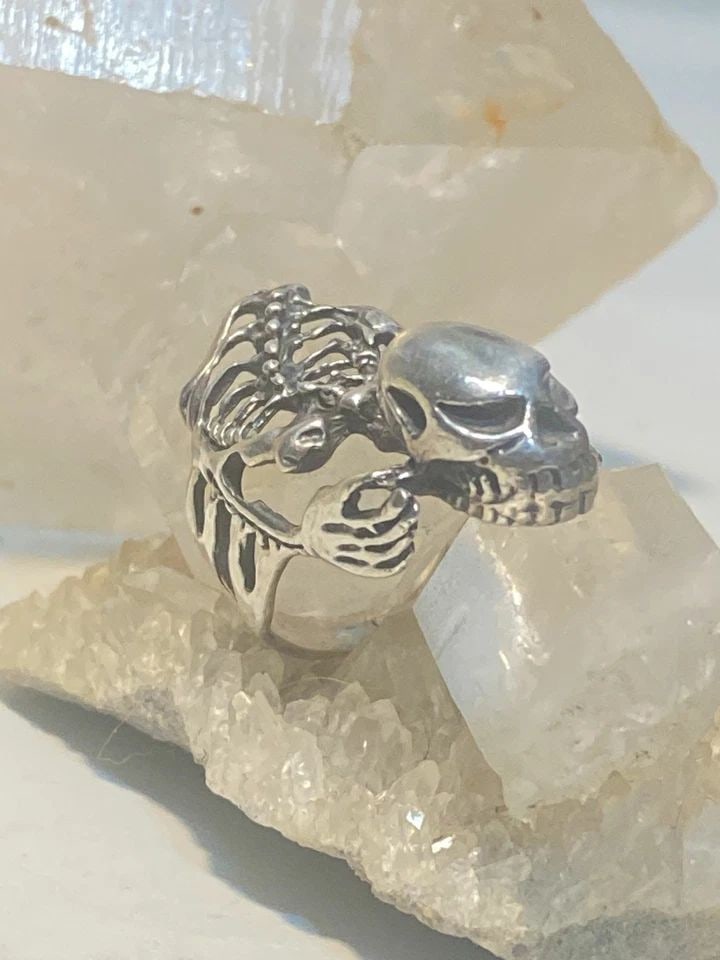 SKULL RING SKELETON BIKER BAND STERLING SILVER WOMEN: SKULL RING SKELETON BIKER BAND STERLING SILVER WOMEN Skull ring skeleton biker band sterling silver women Size 9 AS IS Band Is CUT Weight 11.8g Length. 1. 1/2" Width 3/4" Thinnest part of band 3/16"