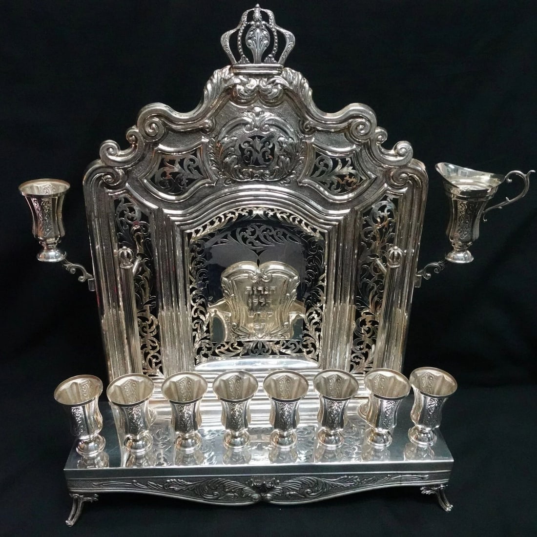 ANTIK STERLING SILVER LEAF ORNATE CHASED CROWN WALL MENORAH 16" X 12.25": ANTIK STERLING SILVER LEAF ORNATE CHASED CROWN WALL MENORAH - 16" X 12.25" Antik Sterling Silver Leaf Ornate Chased Crown Wall Menorah Height - 16" Length - 12.25" Width - 3.25" Total Weight - 3 Lb. 7