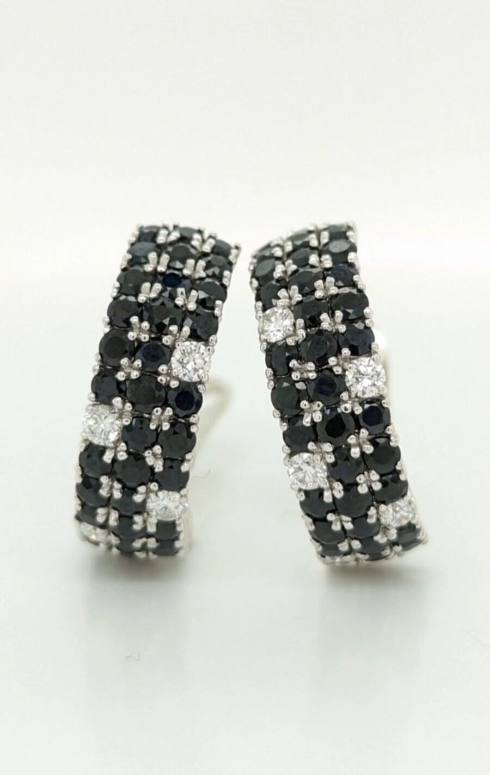 ROBERTO COIN FANTASIA 18K WHITE GOLD DIAMOND BLACK SAPPHIRE HALF HOOP EARRINGS: ROBERTO COIN FANTASIA 18K WHITE GOLD DIAMOND BLACK SAPPHIRE OMEGA BACK EARRINGS Roberto Coin Fantasia 18K White Gold Diamond & Black Sapphire Earrings Total Weight - 14.9 Grams Width - 8mm Length - 1"