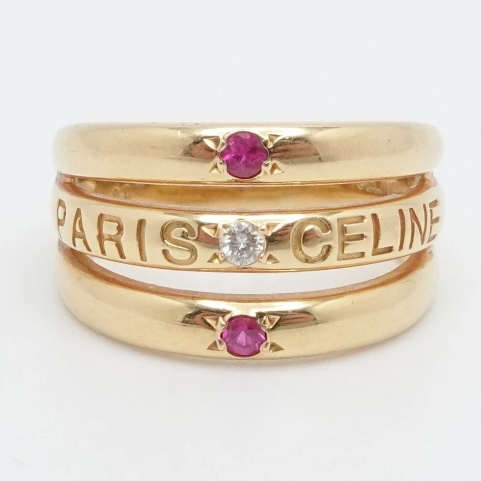CELINE PARIS 18K YELLOW GOLD DIAMOND & RUBY BAND RING - SIZE 6.75: CELINE PARIS 18K YELLOW GOLD DIAMOND & RUBY BAND RING - SIZE 6.75 Celine Paris 18K Yellow Gold Diamond & Ruby Band Ring Ring Size - 6.75 Total Weight - 7.0 Grams Width - 3.5mm - 11mm Great Condition &
