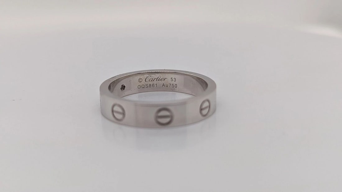 CARTIER LOVE WEDDING 4MM BAND 1 DIAMOND RING 18K WHITE GOLD - SIZE 53 / 6.25: Cartier Love Wedding Band 1 Diamond Ring 18K White Gold Ring Size - 53 / 6.25 Width - 4mm Total Weight - 5.4 Grams Diamond Size - 0.02 Carats Retail Price - $2530.00 + Tax Pouch & Proof of Purchase In
