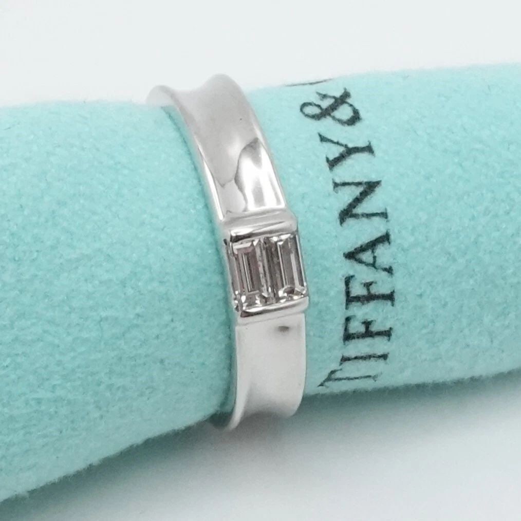 1997 TIFFANY & CO. 18K WHITE GOLD BAGUETTE DIAMOND WEDDING BAND RING SIZE 6.75: 1997 Tiffany & Co. 18K White Gold Baguette Diamond Wedding Band Ring Size - 6.75 Band Width - 4mm Est. Retail Price - $2,250 USD Total Weight - 5.2 Grams Pouch NOT Included Very Great & Professionally