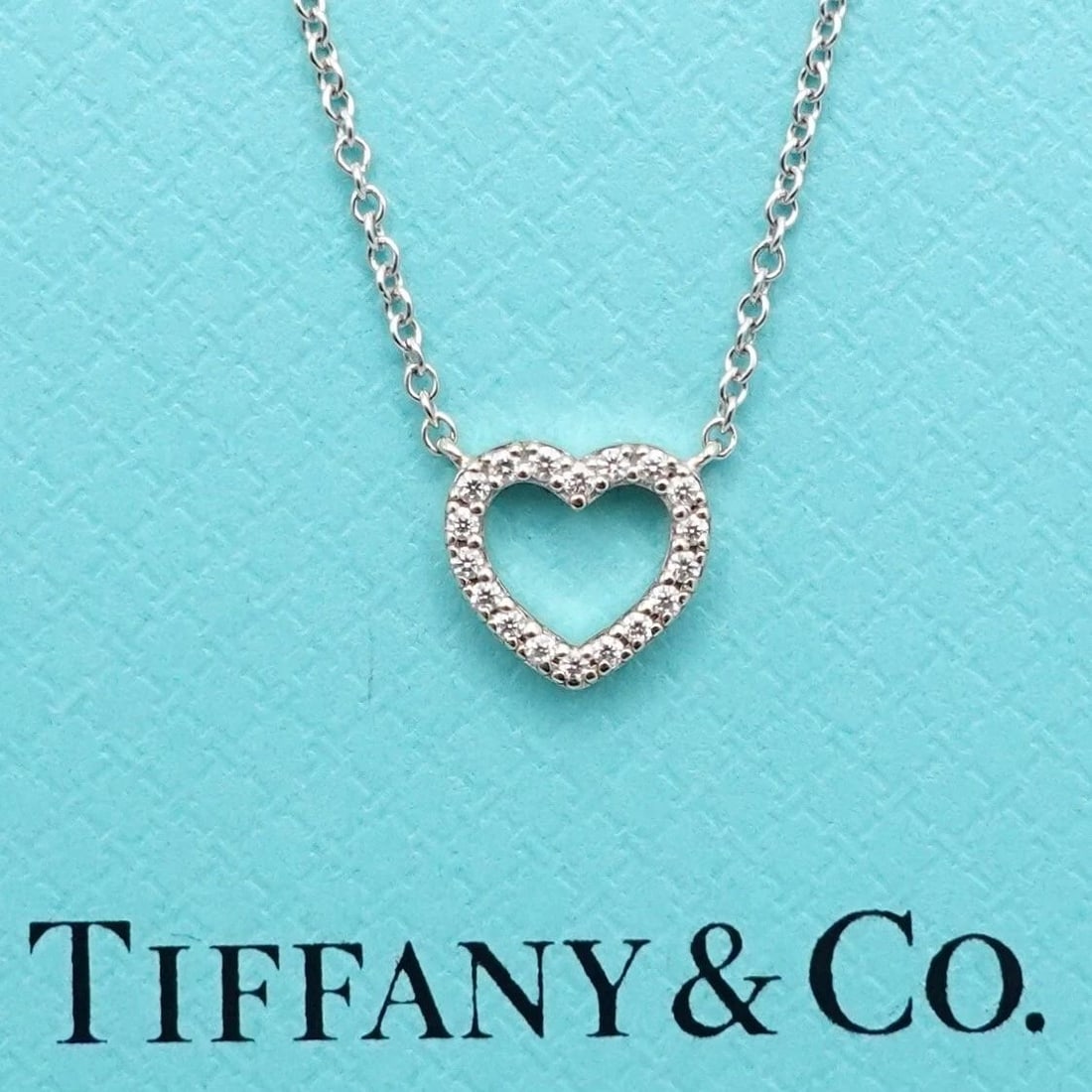 TIFFANY & CO. METRO 18K WHITE GOLD DIAMOND HEART MINI PENDANT NECKLACE 16" BOX: Tiffany & Co. Metro 18K White Gold Diamond Heart Mini Pendant Necklace Length - 16" Chain Width - 0.5mm approx. Dimension - 7.6mm x 8mm approx. Total Weight - 1.9 Grams Est. Retail Price - $2,150 USD 