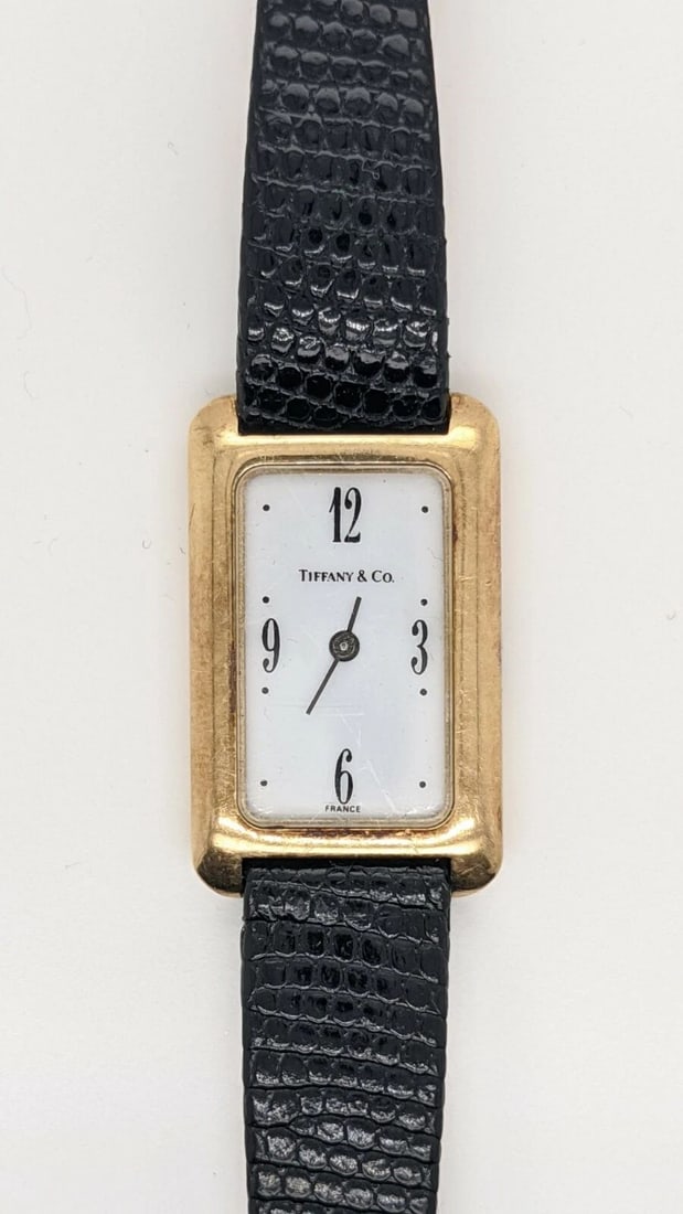 TIFFANY & CO. 14K YELLOW GOLD TANK WATCH - 18MM X 30MM: Tiffany & Co. 14K Yellow Gold Tank Watch with Hirsch after market lizard leather strap Case Size - 18mm x 30mm Total Length - 8.5" Long Great Condition & Keeps Accurate Time New Battery Installed 8/10