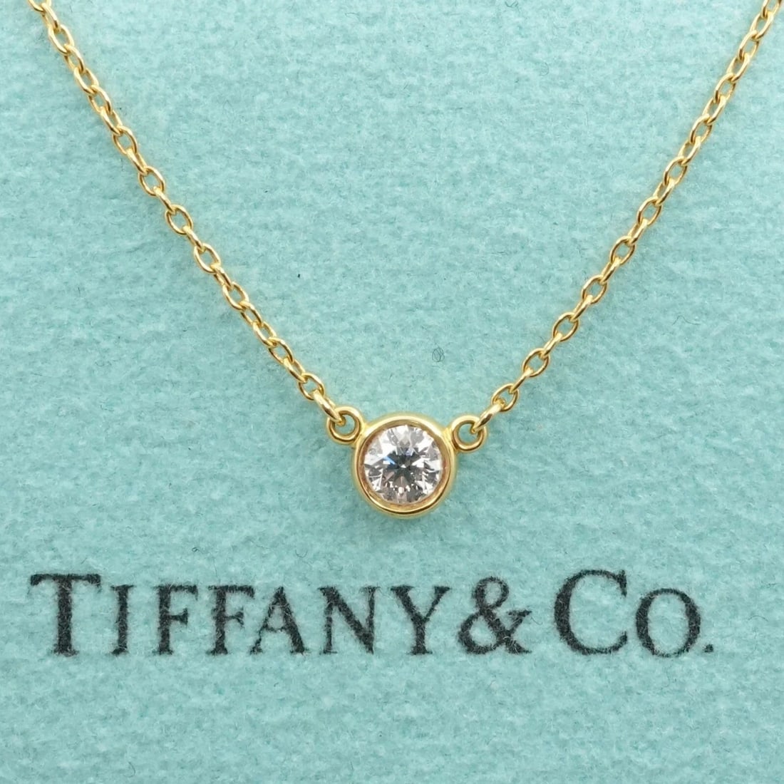 TIFFANY & CO. PERETTI DIAMONDS BY THE YARD SINGLE DIAMOND BRILLIANT NECKLACE: TIFFANY & CO. PERETTI DIAMONDS BY THE YARD SINGLE BRILLIANT SOLITAIRE NECKLACE Tiffany & Co. Elsa Peretti Diamonds By The Yard Bezel Round Brilliant Cut Solitaire Necklace Length - 18.75" Long Chain W