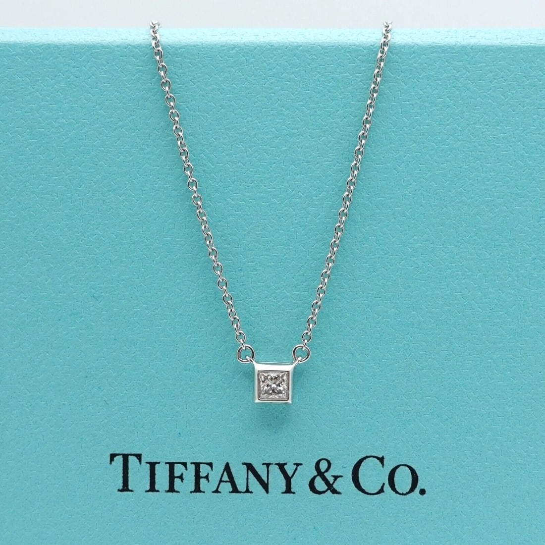 TIFFANY & CO. PLATINUM PRINCESS DIAMOND MINI PENDANT NECKLACE 16" BOX & RECEIPT: Tiffany & Co. Platinum Princess Diamond Mini Charm Pendant Necklace Length - 16" Pendant Width - 4mm Total Weight - 2.4 Grams Date of Purchase - 05/27/2011 Box, Case, & Proof of Purchase Included